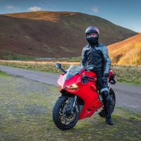 Red Motorbike with Rider / Red Motorbike with rider in Upper Coquetdale, Northumberland on a sunny day